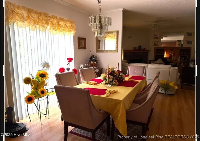 a view of a dining room with furniture and a window