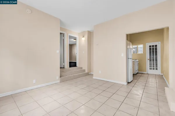 a kitchen with cabinets appliances a sink and a window