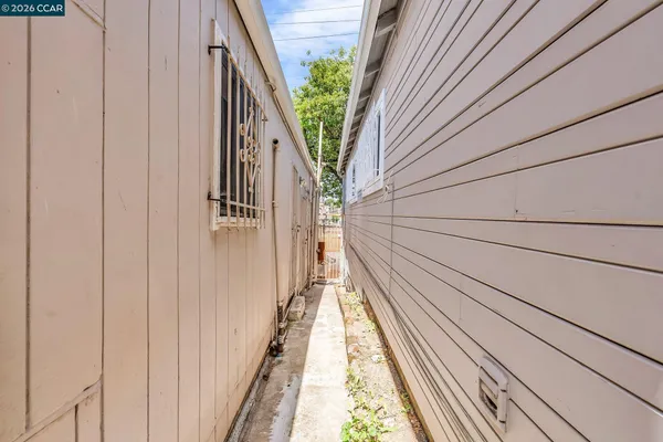 a view of a house with a wooden fence