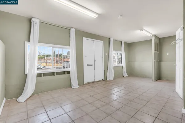a view of an empty room and a bathroom