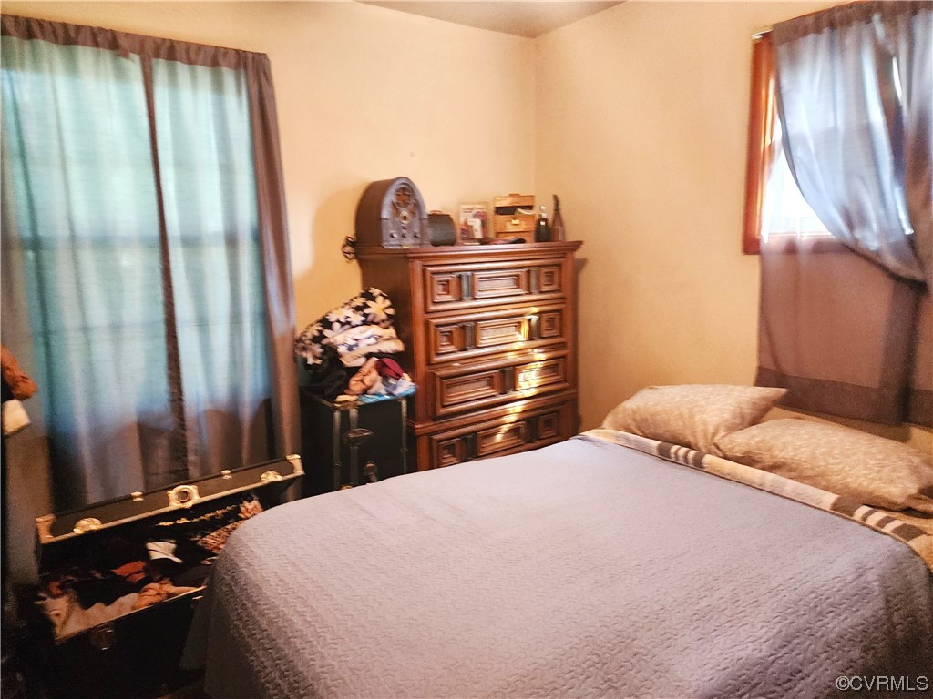 2315 Tignor Road Richmond, VA 23224 - Photo 17 of 23 a bedroom with a bed and a chandelier