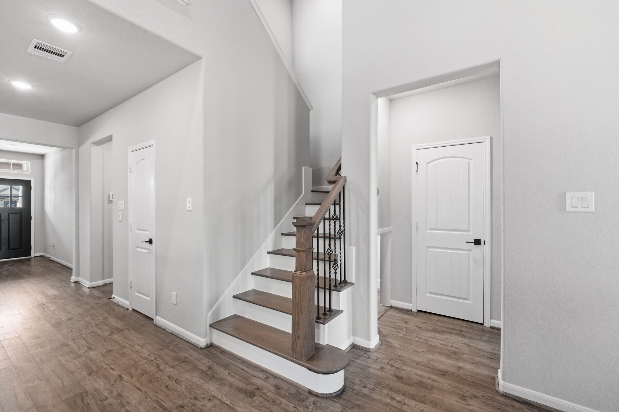 4334 Umber Shadow Drive Spring, TX 77386 - Photo 20 of 45 Foyer showcases a staircase with decorative balusters, durable wood-look flooring, and a welcoming entry that opens to the home's main living areas.