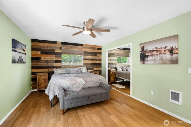 a bedroom with a bed and wooden floor