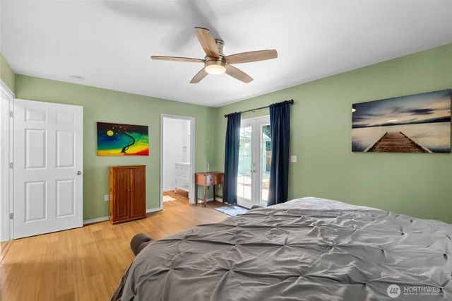 a bedroom with a bed and a chandelier