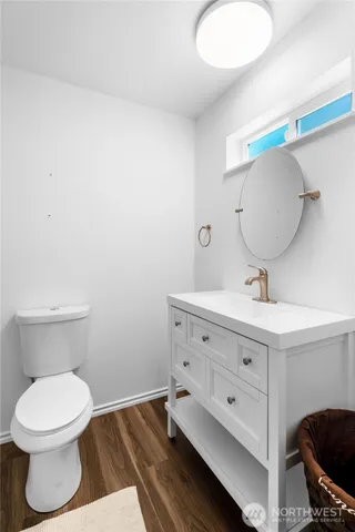 a bathroom with a toilet a sink and mirror