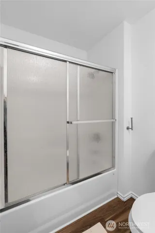 a bathroom with a shower and a toilet