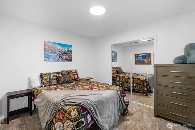 a bedroom with a bed and a dresser