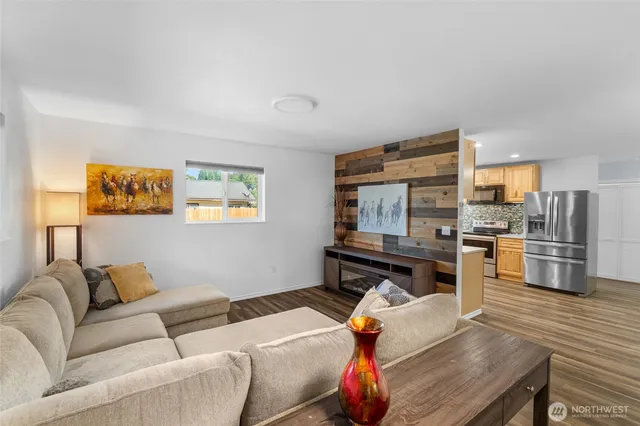 a living room with furniture and kitchen view