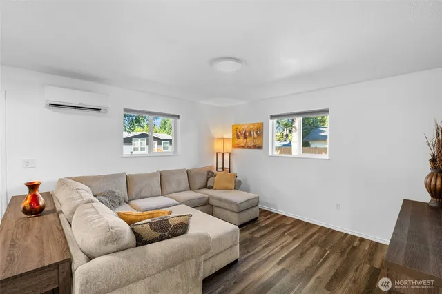 a living room with furniture and a wooden floor