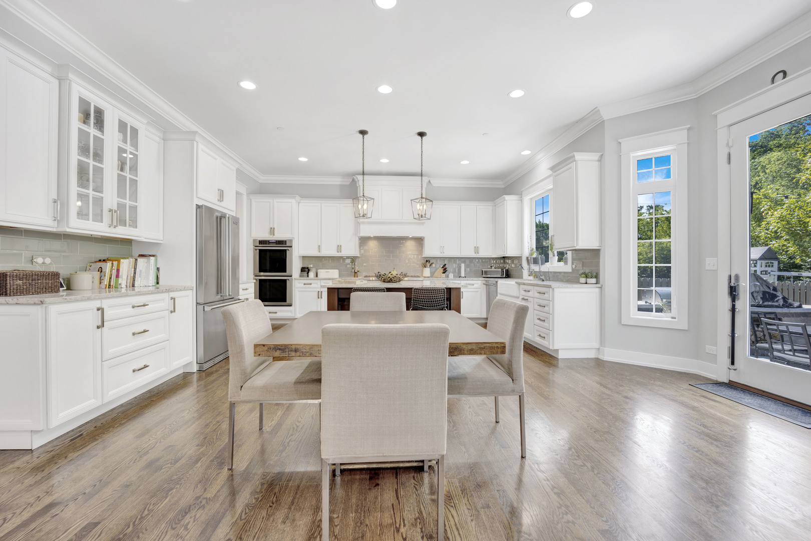 355 St Charles Road Glen Ellyn, IL 60137 - Photo 11 of 44 a kitchen with stainless steel appliances white cabinets and wooden floors