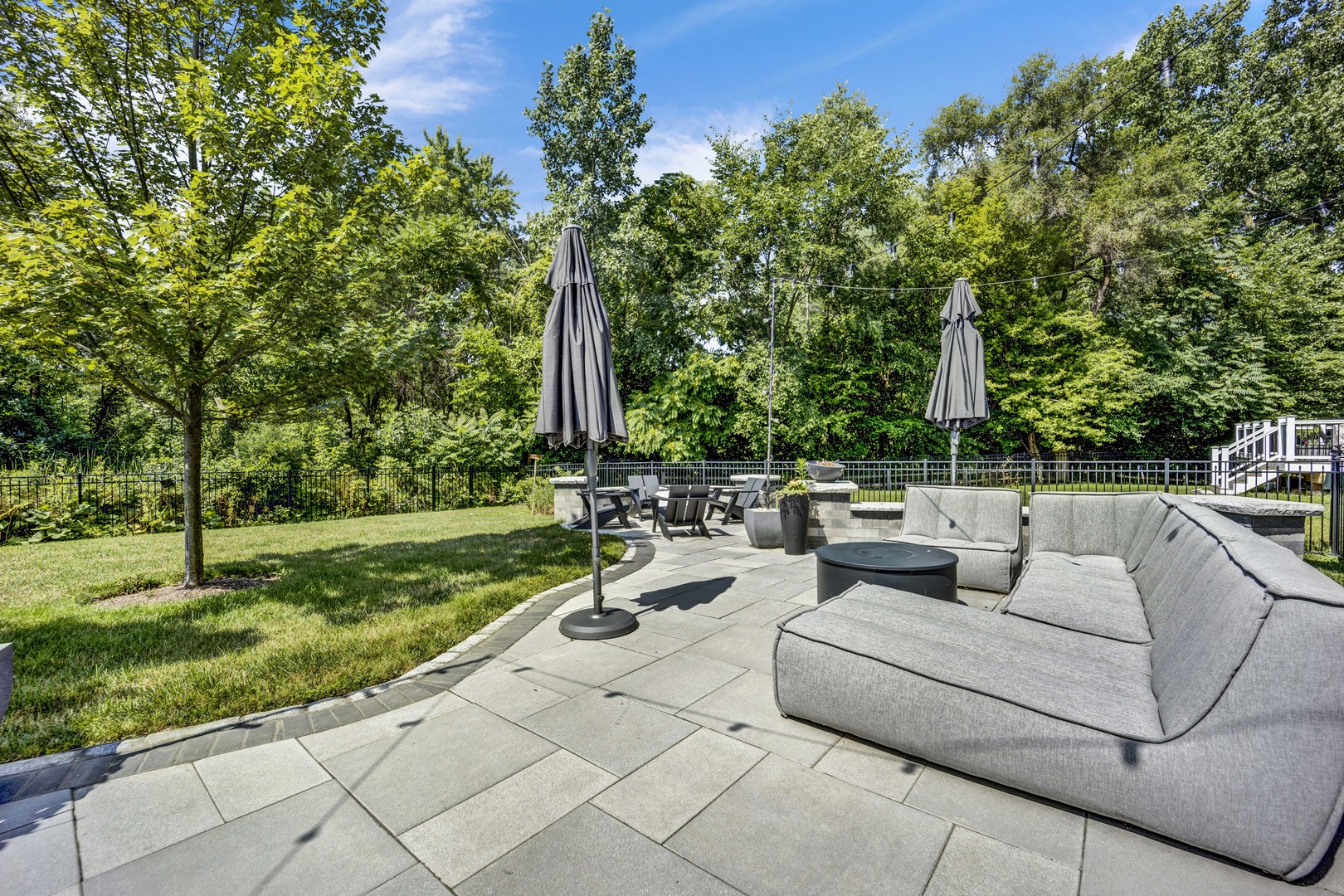 355 St Charles Road Glen Ellyn, IL 60137 - Photo 17 of 44 a view of a patio with couches and a table and chairs with wooden fence
