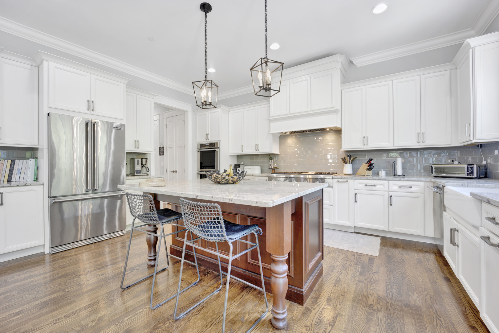 355 St Charles Road Glen Ellyn, IL 60137 - Photo 7 of 44 a kitchen with stainless steel appliances granite countertop a refrigerator a stove a sink dishwasher a refrigerator and white cabinets with wooden floor