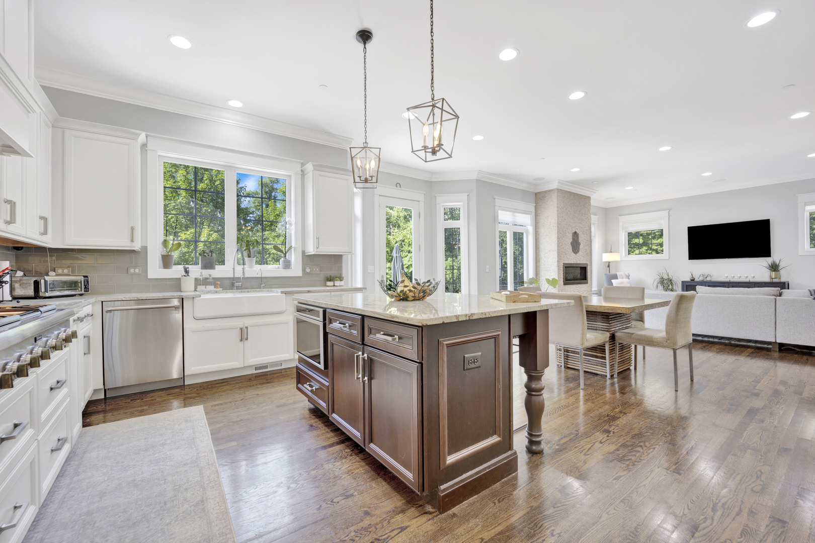 355 St Charles Road Glen Ellyn, IL 60137 - Photo 9 of 44 a large kitchen with kitchen island granite countertop a large center island a stove and a window