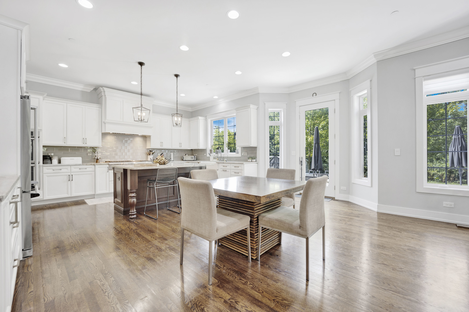 355 St Charles Road Glen Ellyn, IL 60137 - Photo 10 of 44 a view of a dining room and livingroom with furniture wooden floor a rug and a large window