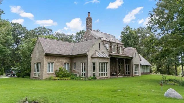 a front view of a house with a garden