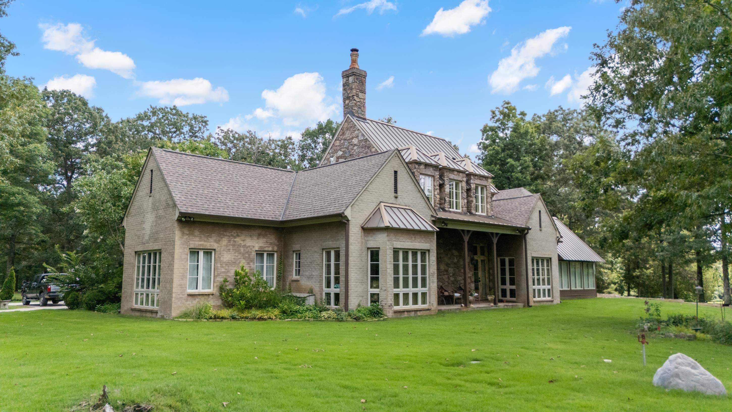 a front view of a house with a garden