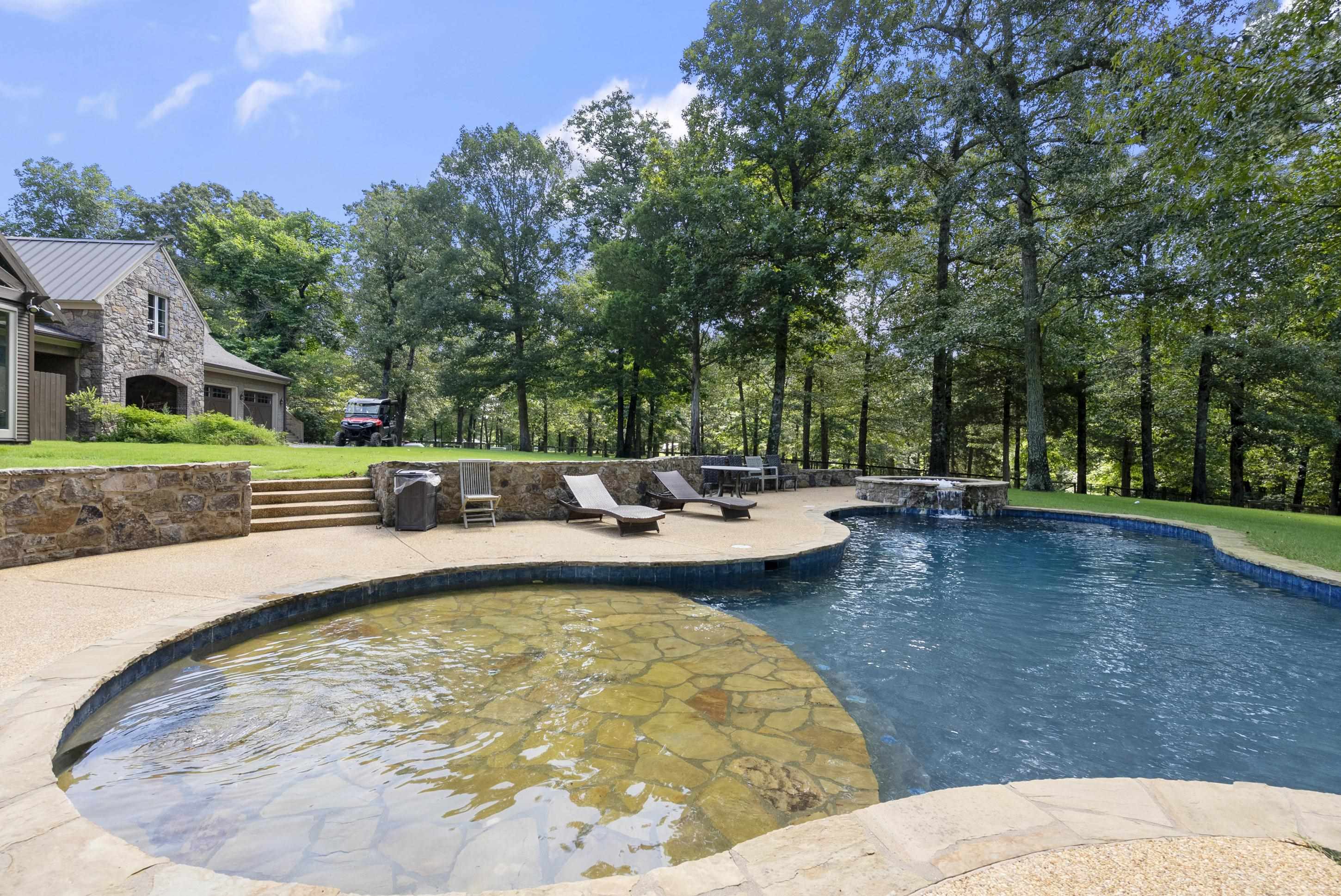891 Musgray Road Holly Springs, MS 38635 - Photo 2 of 38 a view of swimming pool with lawn chairs and plants