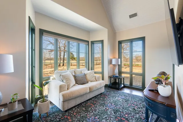 a spacious bedroom with a bed and a large window