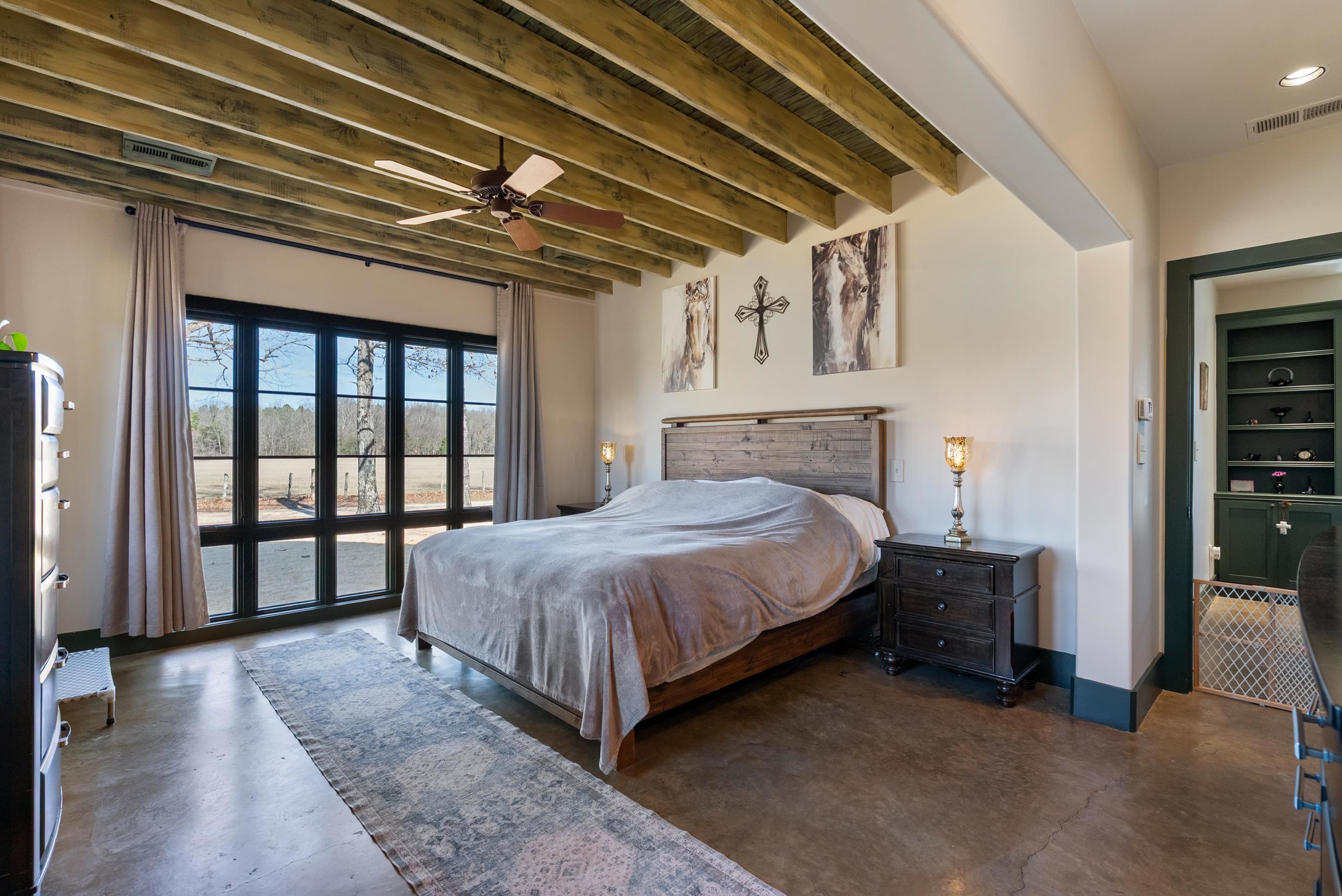 891 Musgray Road Holly Springs, MS 38635 - Photo 24 of 38 a spacious bedroom with a bed and a large window