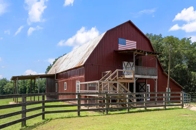 a patio with glass top table and chairs