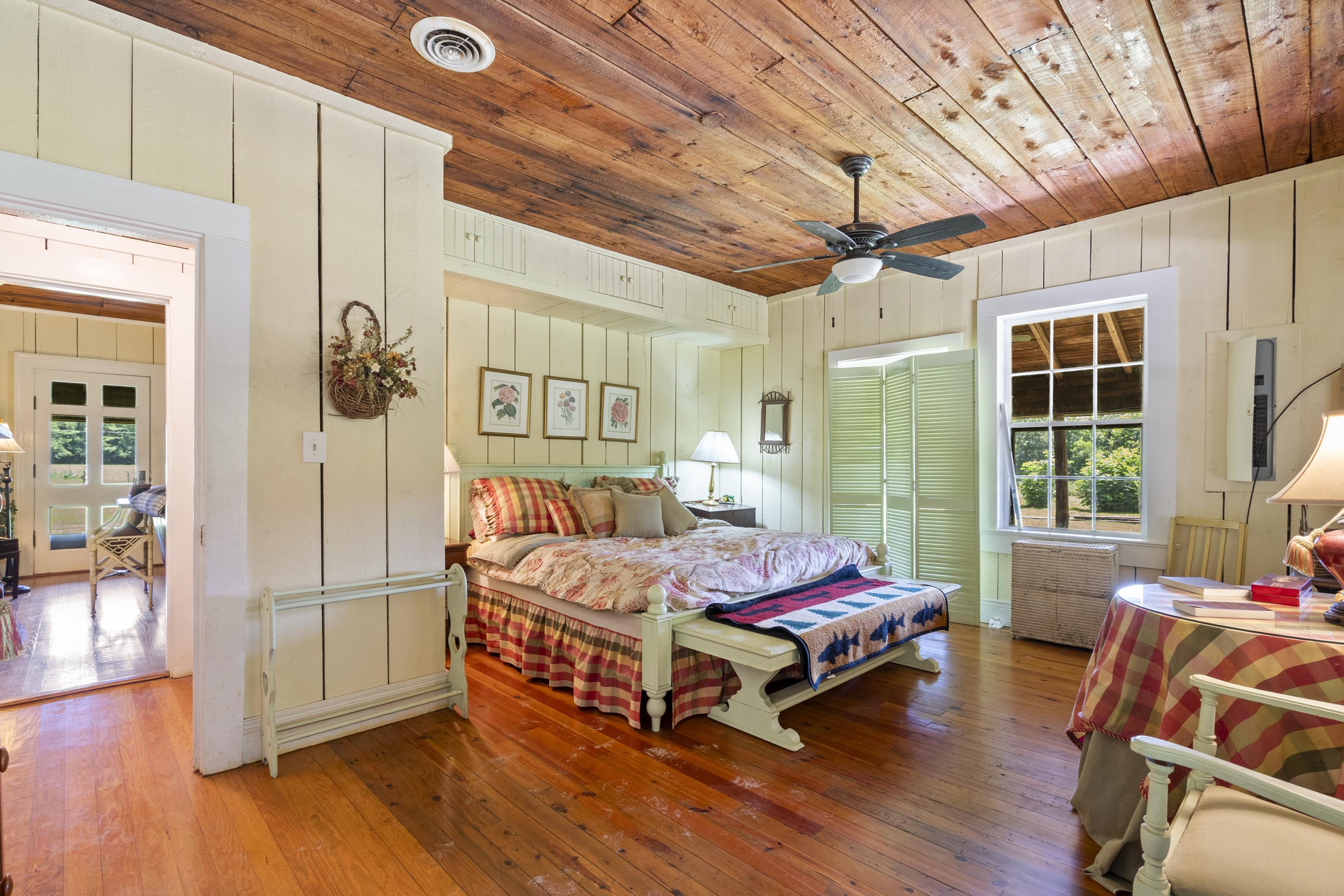 891 Musgray Road Holly Springs, MS 38635 - Photo 32 of 38 a bedroom with a bed and wooden floor