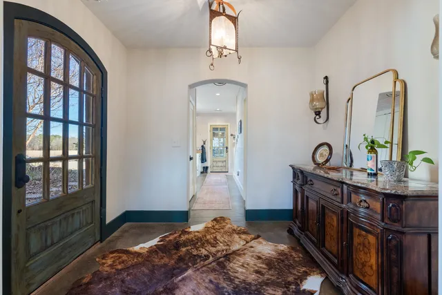 a bedroom with a bed and a mirror on the dresser