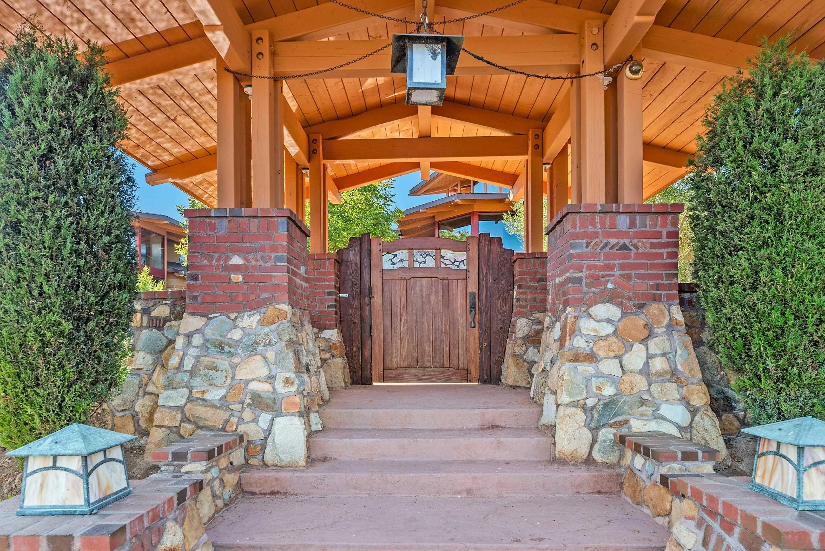 15535 Westview Road Poway, CA 92064 - Photo 23 of 74 a view of a brick house with a large windows and flower plants