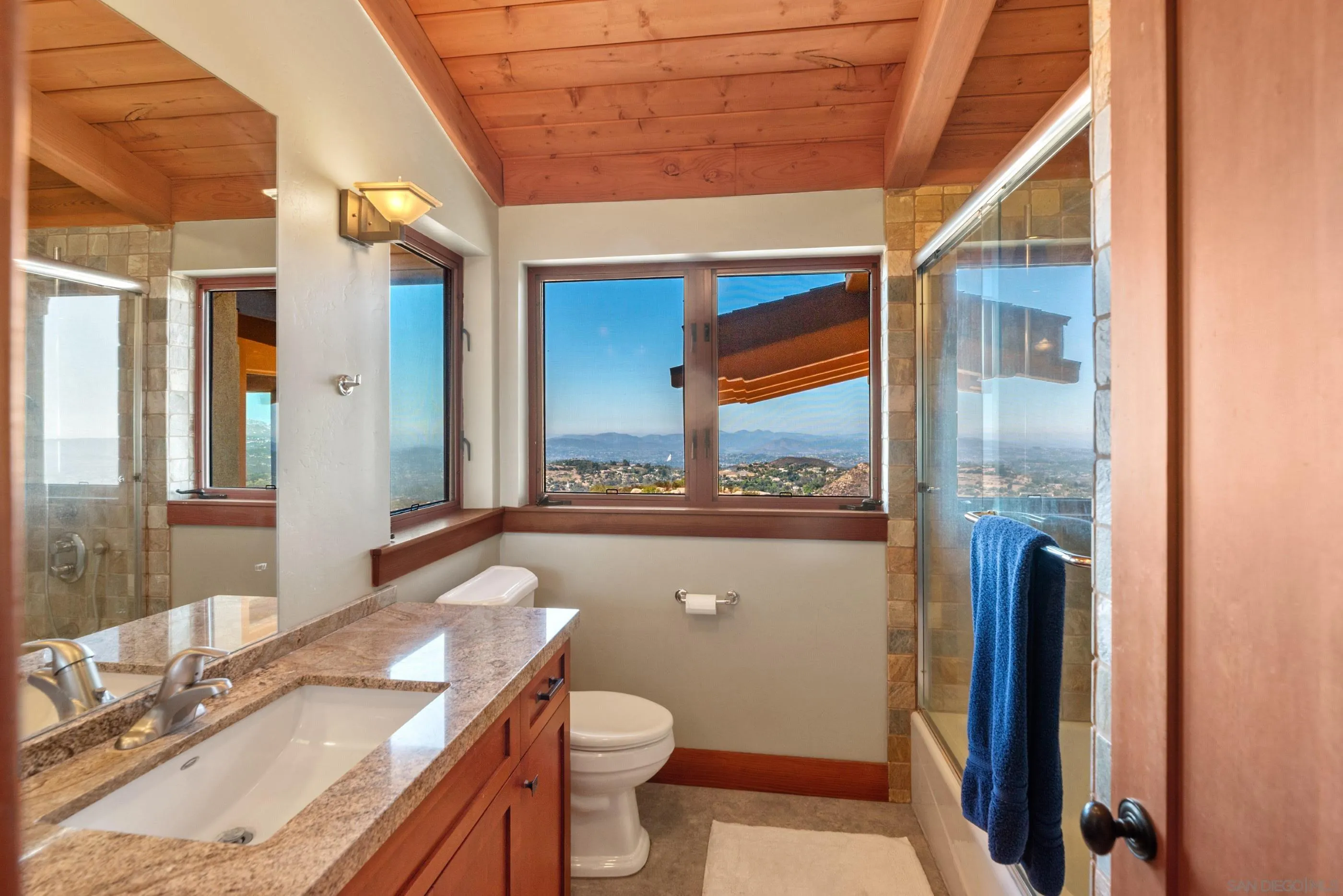 15535 Westview Road Poway, CA 92064 - Photo 70 of 74 a bathroom with a granite countertop sink toilet and shower