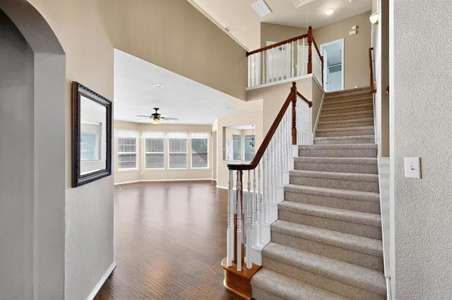 a view of entryway with wooden floor and front door