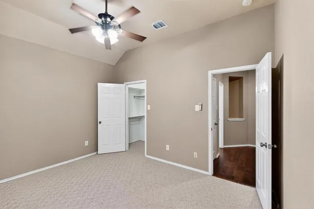 a view of a big room with chandelier fan