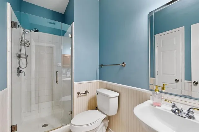 a bathroom with a sink toilet and shower