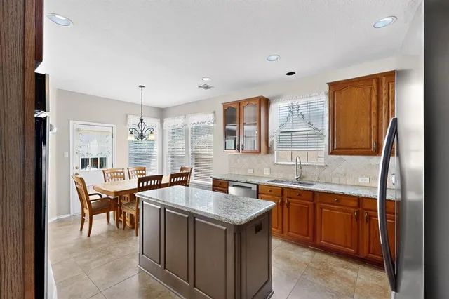 a kitchen with a sink counter and chairs
