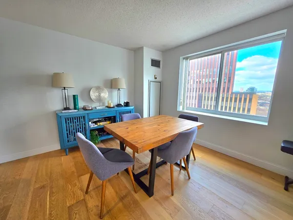 a dining room with furniture and window