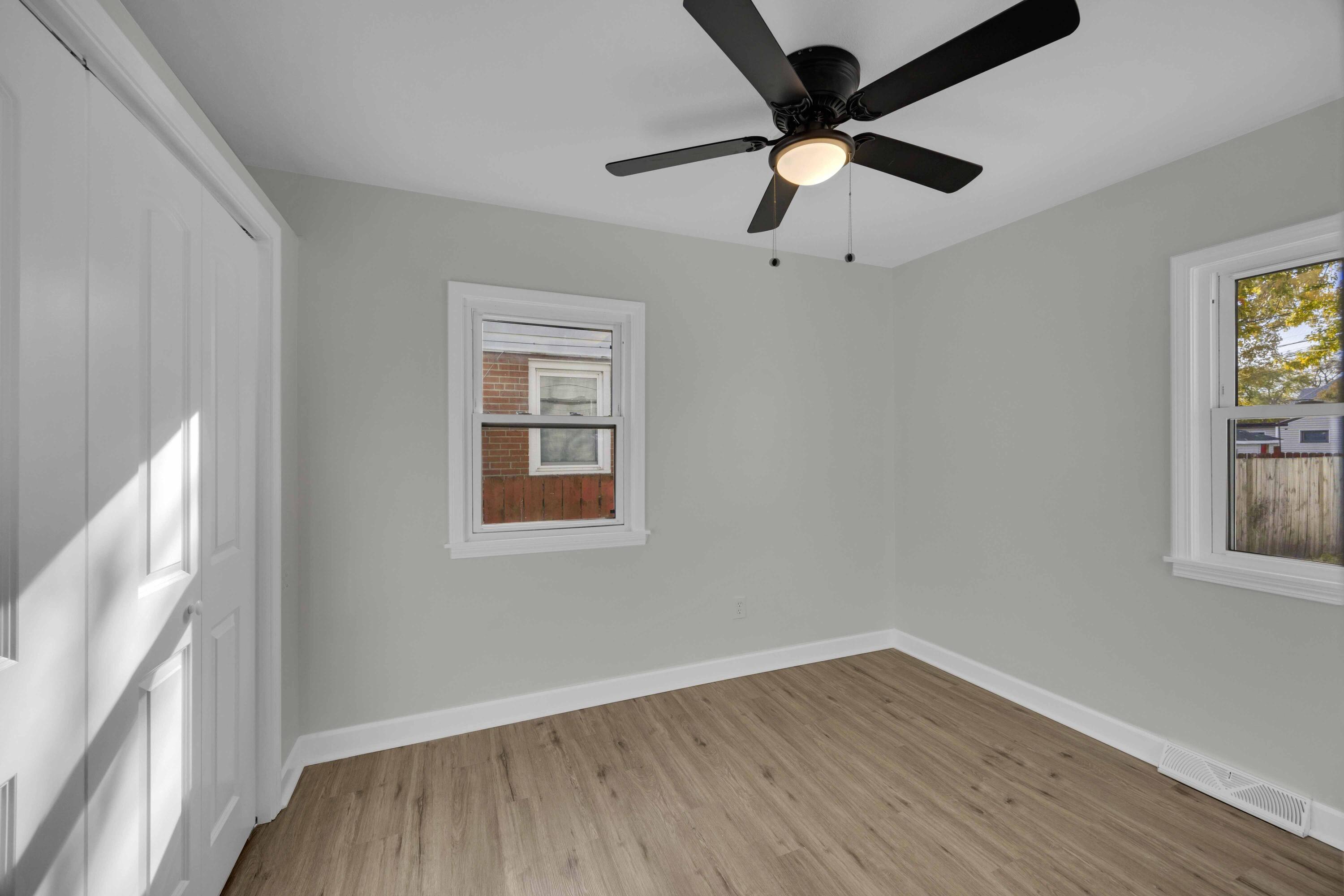 5428 Chestnut Avenue Hammond, IN 46320 - Photo 11 of 20 an empty room with wooden floor fan and windows