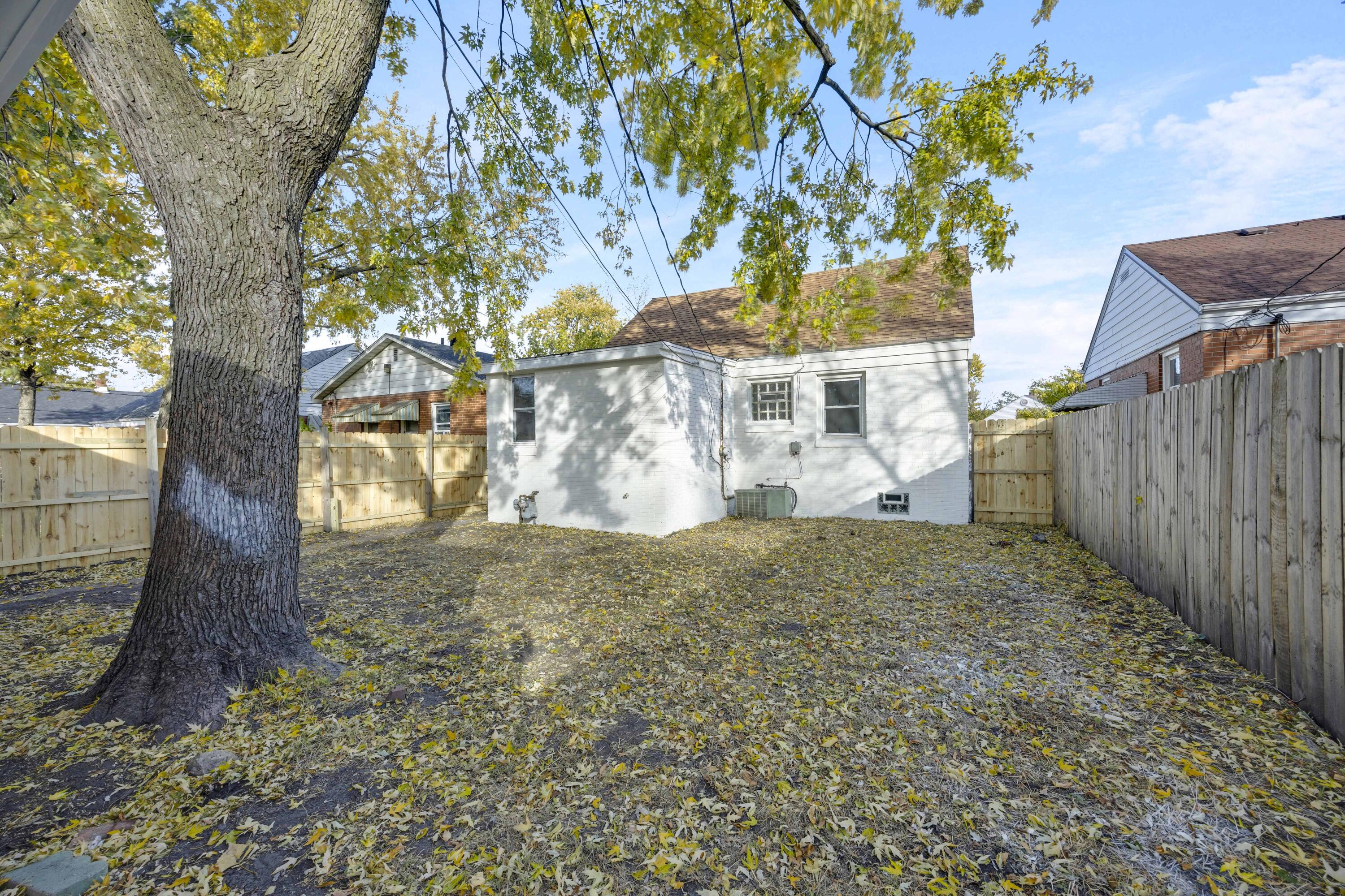 5428 Chestnut Avenue Hammond, IN 46320 - Photo 20 of 20 a view of a yard in front of a house with large tree