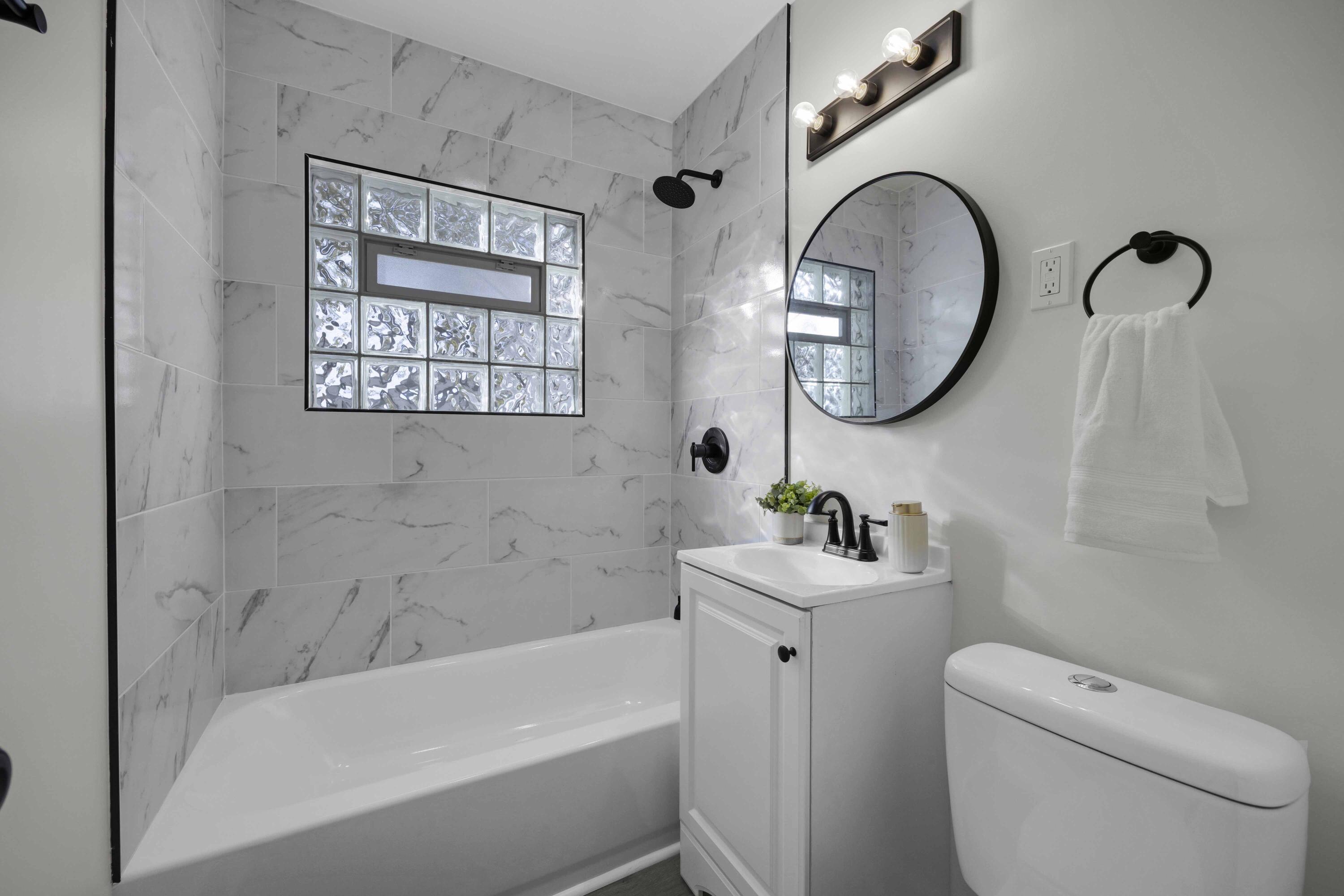 5428 Chestnut Avenue Hammond, IN 46320 - Photo 9 of 20 a bathroom with a toilet a sink and a bathtub