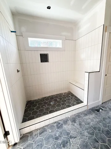 a bathroom with a glass door shower