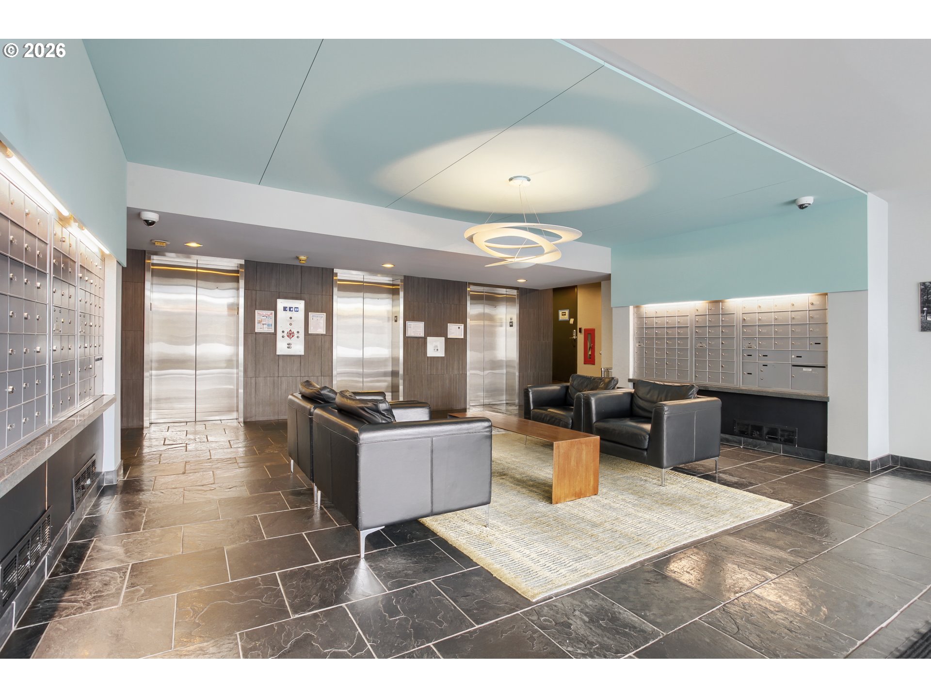 111 Southwest Harrison Street, Unit 4G Portland, OR 97201 - Photo 3 of 13 a living room with furniture a large window and potted plants