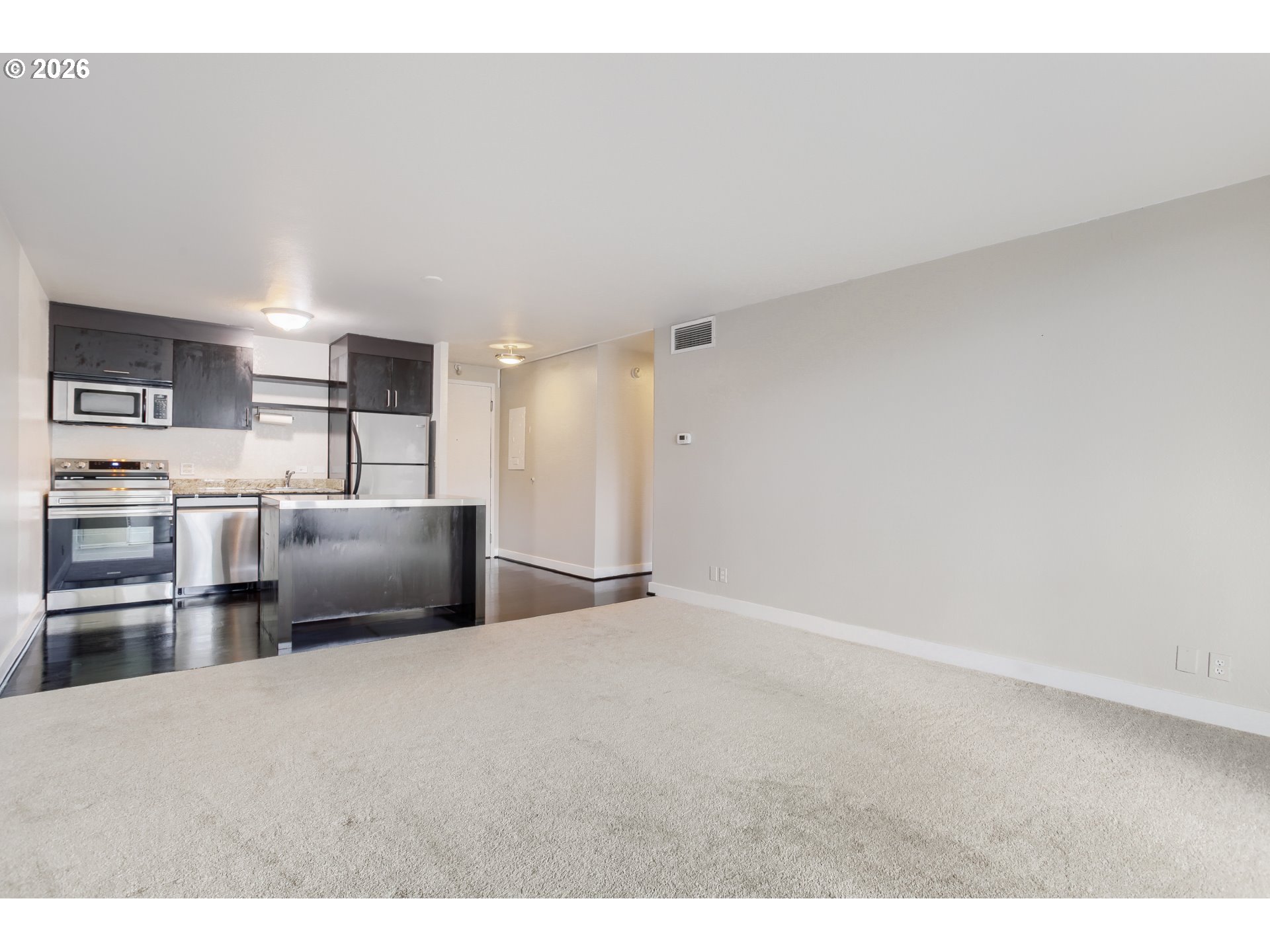 111 Southwest Harrison Street, Unit 4G Portland, OR 97201 - Photo 5 of 13 a kitchen with refrigerator and cabinets