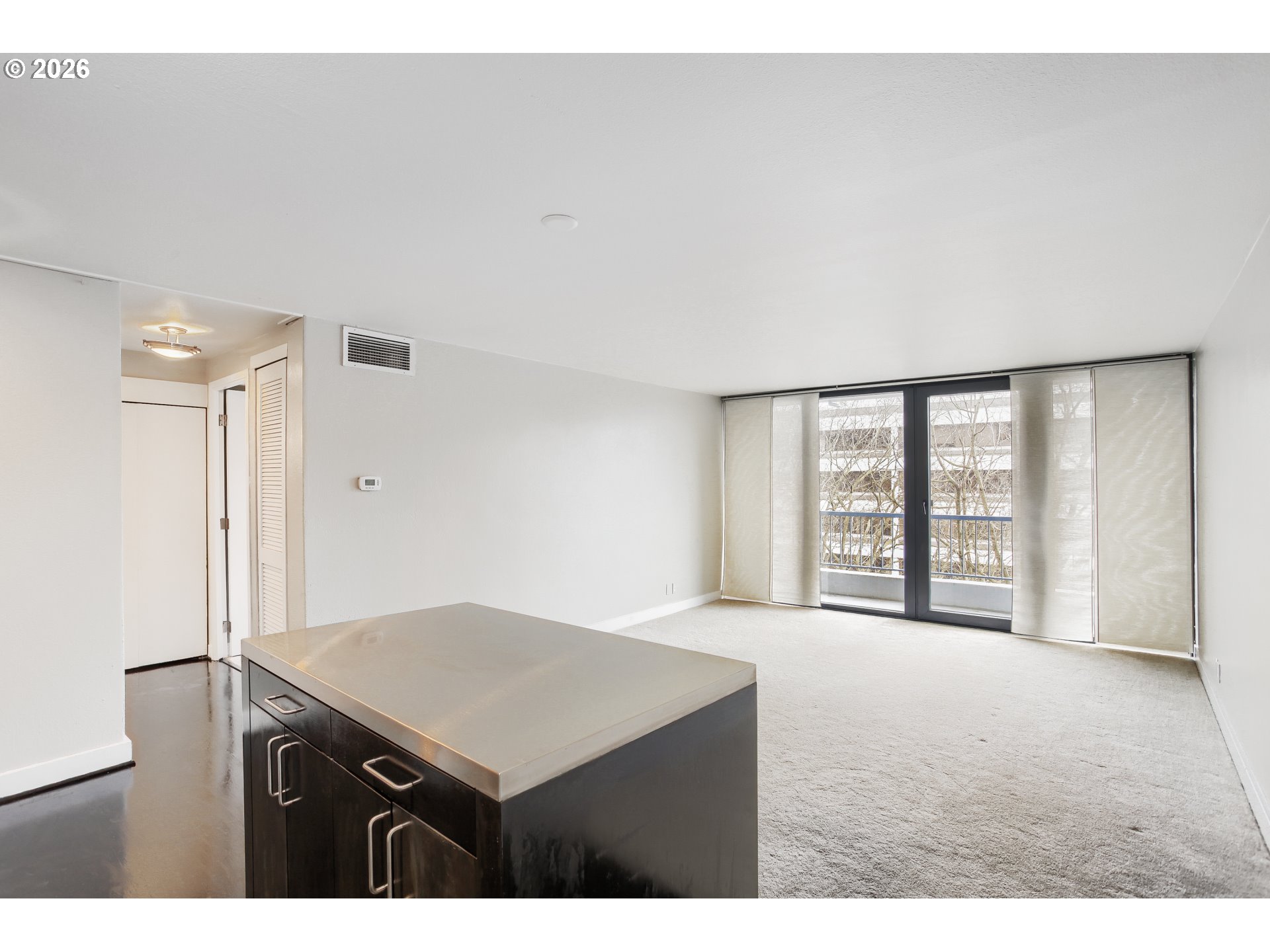 111 Southwest Harrison Street, Unit 4G Portland, OR 97201 - Photo 6 of 13 a living room with a bed furniture and a large window