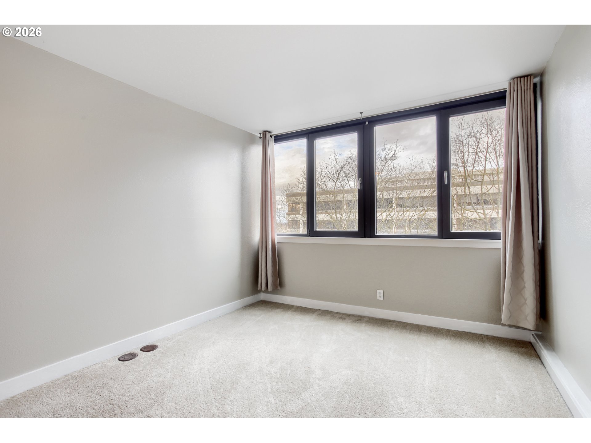 111 Southwest Harrison Street, Unit 4G Portland, OR 97201 - Photo 8 of 13 a view of an empty room with a window