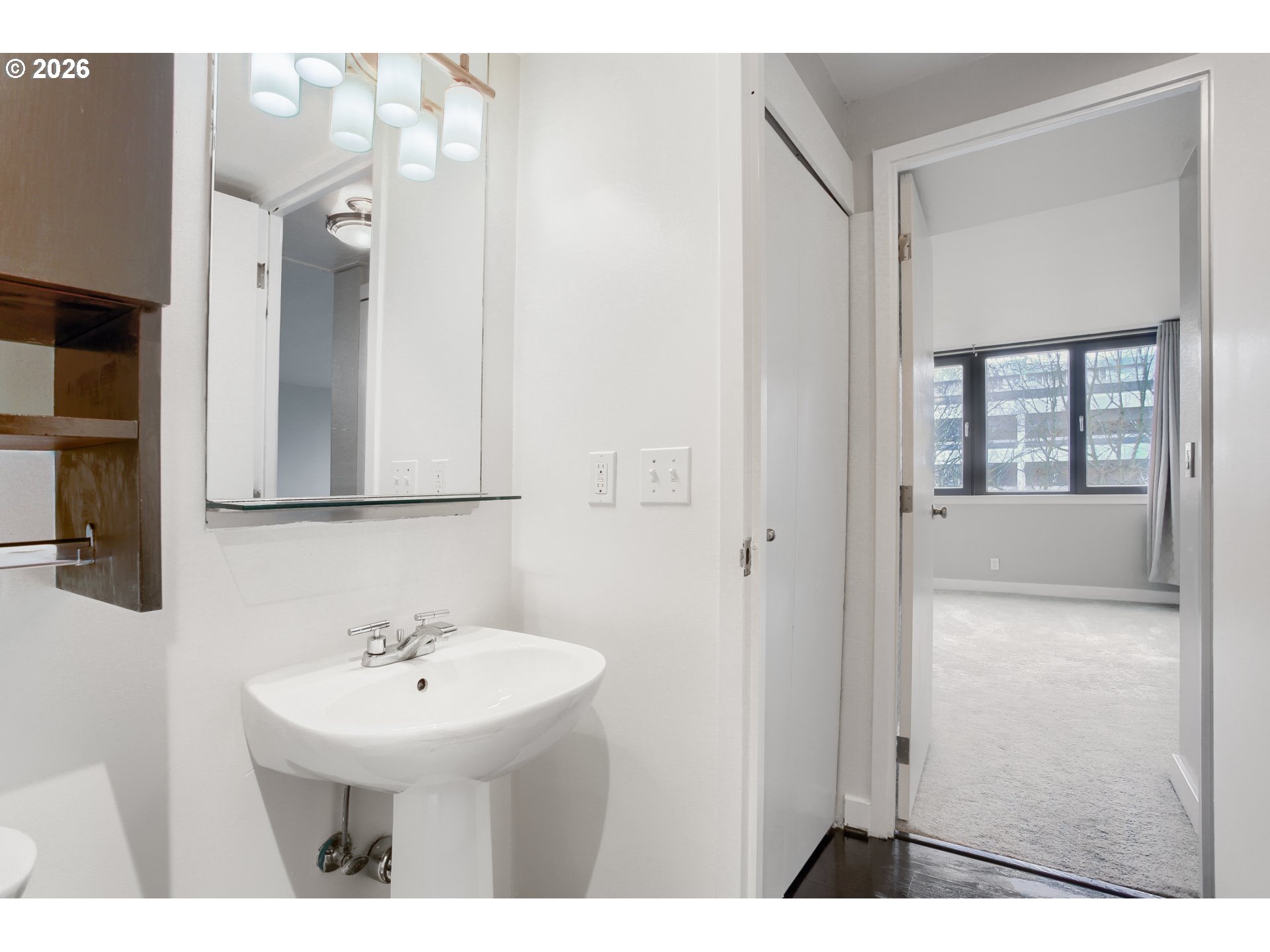 111 Southwest Harrison Street, Unit 4G Portland, OR 97201 - Photo 10 of 13 a bathroom with a sink a mirror and shower
