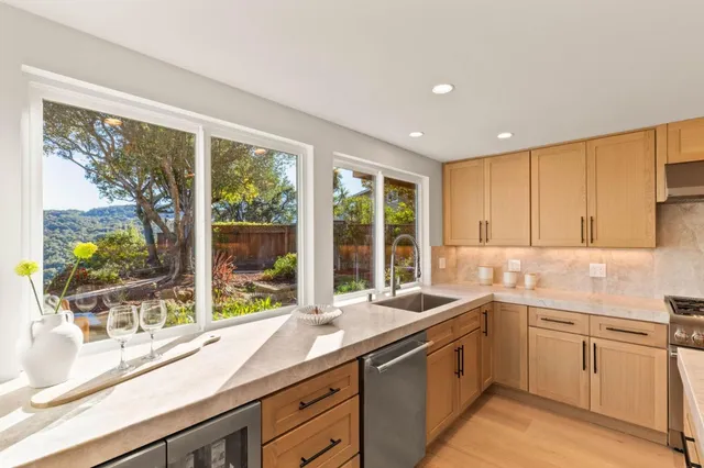 a kitchen with white cabinets and appliances