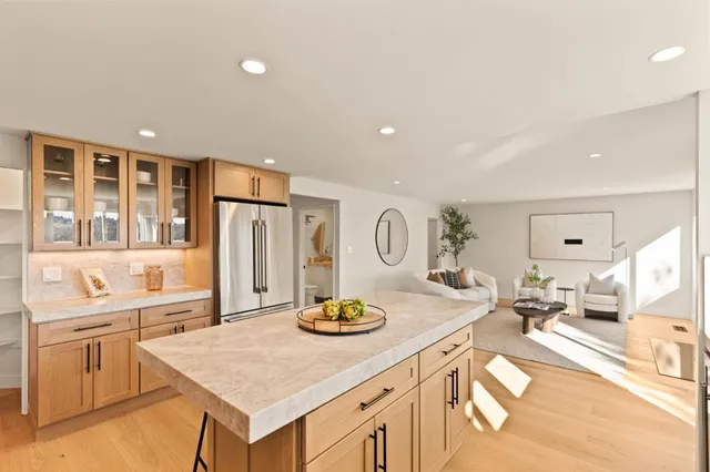 a kitchen with stainless steel appliances kitchen island granite countertop a sink and cabinets