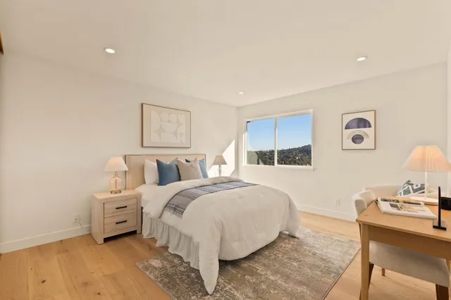 a bed room with a bed and a chair