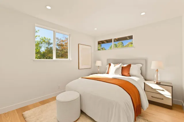 a bedroom with a bed and a painting on the wall