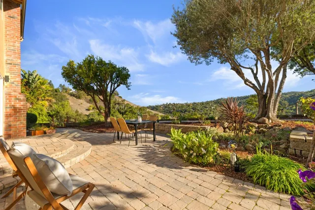 an aerial view of a house with a yard and lake view