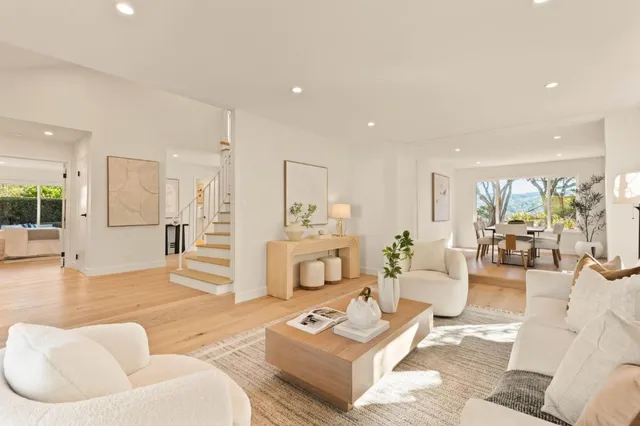 a view of a dining room with furniture large window and wooden floor