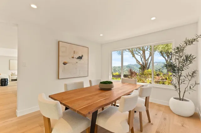 a living room with furniture a fireplace and a potted plants