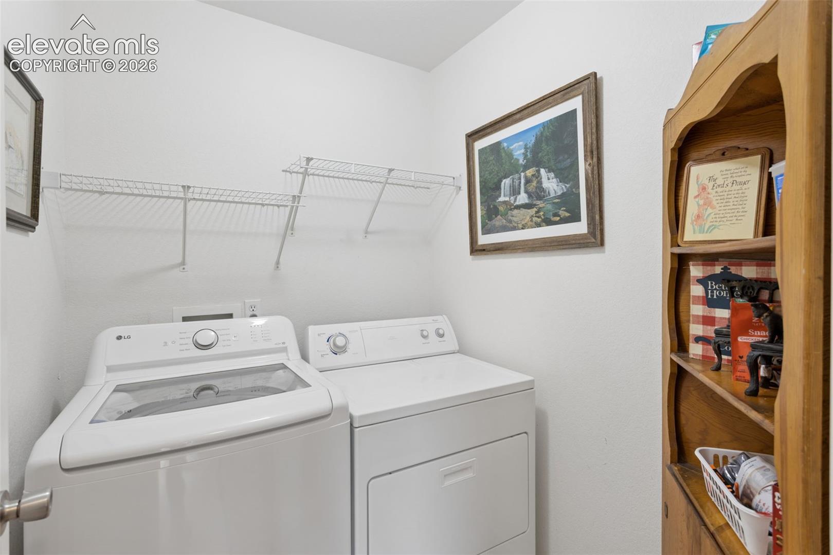 9351 Bethpage Road Peyton, CO 80831 - Photo 13 of 32 White washer and dryer appliances with overhead wire shelving